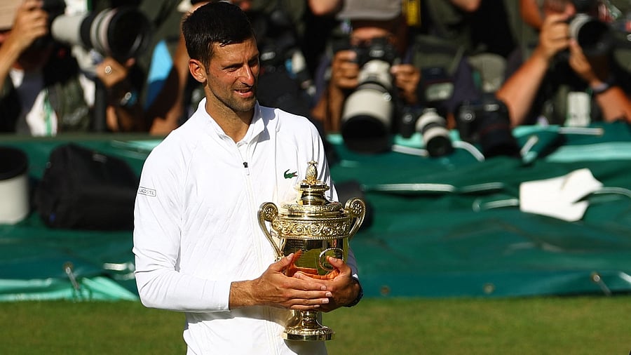 Serbia's Novak Djokovic poses with the Wimbledon trophy after winning the men's singles final against Australia's Nick Kyrgios. Credit: Reuters photo