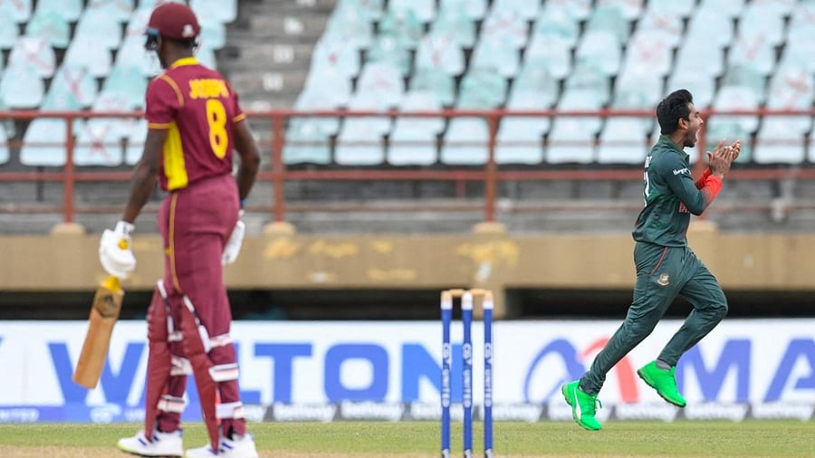 Mehidy Hasan Miraz (R) of Bangladesh celebrates the dismissal of Alzarri Joseph (L) of West Indies during the 2nd ODI match between West Indies and Bangladesh at Guyana National Stadium. Credit: AFP Photo