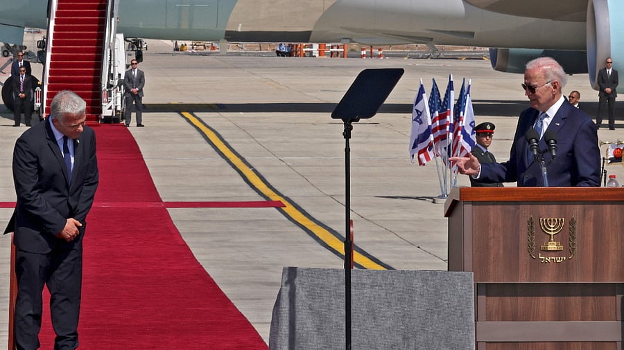 US President Joe Biden (right) and Israeli PM Yair Lapid (left) at the Ben Gurion Airport in Tel Aviv, July 13, 2022. Credit: AFP Photo