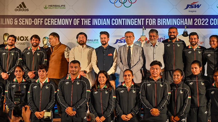Union Sports Minister Anurag Thakur with Indian contingent during the kit unveiling and send-off ceremony for the Birmingham 2022 Commonwealth Games. Credit: PTI Photo