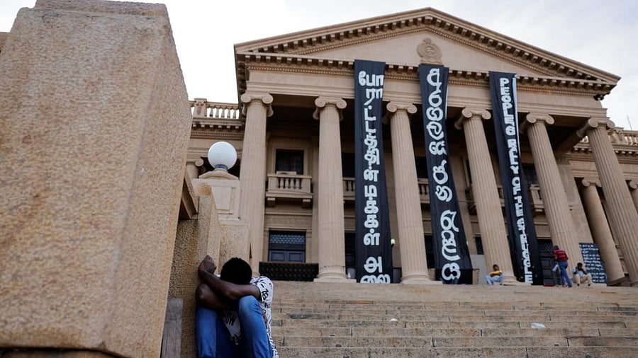 A demonstrator sleeps at the Presidential Secretariat after Parliament Speaker Mahinda Yapa Abeywardena officially announced the resignation of president Gotabaya Rajapaksa who fled to Singapore amid Sri Lanka's economic crisis. Credit: Reuters Photo