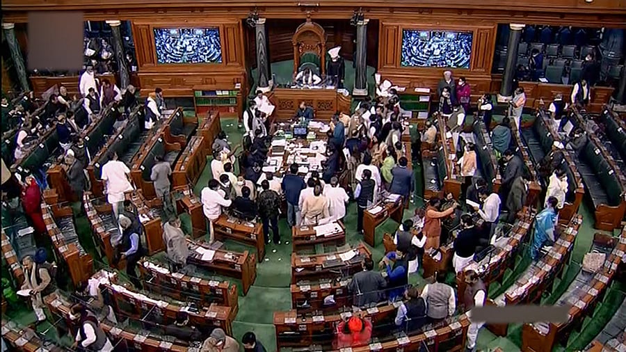 **EDS: TV GRAB** New Delhi: Opposition MPs protest in the Lok Sabha during the Winter Session of Parliament, in New Delhi, Monday, Dec. 20, 2021. (LSTV/PTI Photo)(PTI12_20_2021_000215B)