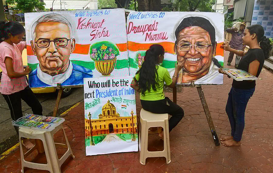 Artists paint portraits of presidential candidates Droupadi Murmu and Yashwant Sinha, on the eve of presidential elections, in Mumbai. Credit: PTI Photo