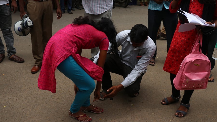 A candidate removes her anklet before appearing for the NEET UG exam. Credit: IANS Photo/ Representative photo