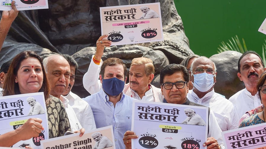  Congress MP Rahul Gandhi with party MPs and other opposition parties' MPs during a protest against inflation and the decision to increase GST on food items, near the Gandhi statue at Parliament complex, in New Delhi, Tuesday, July 19, 2022. Credit: PTI Photo