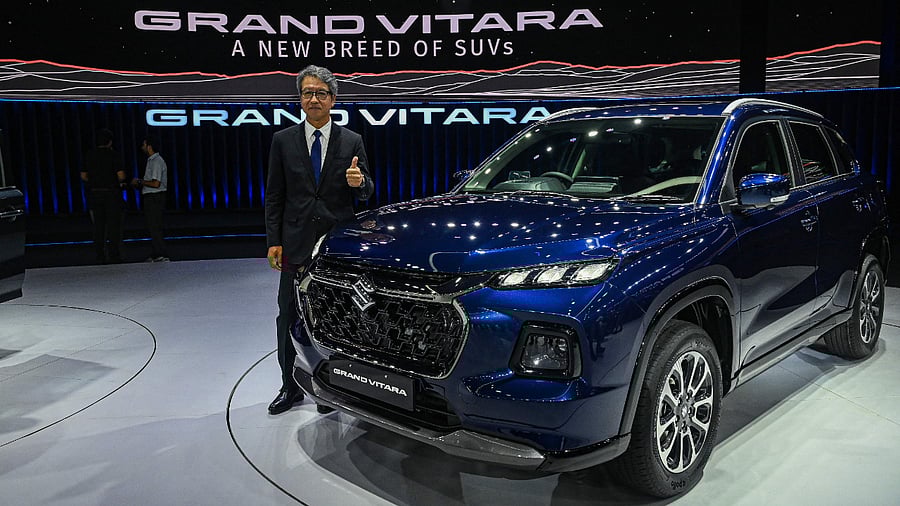 Maruti Suzuki India MD and CEO Hisashi Takeuchi poses with the new SUV Grand Vitara in Gurgaon on July 20, 2022. Credit: AFP Photo