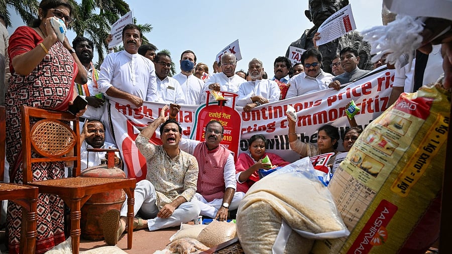 Congress MP Rahul Gandhi with Mallikarjun Kharge and other opposition MPs during a protest against inflation and the decision to increase GST on food items, near the Gandhi statue at Parliament complex. Credit: PTI Photo