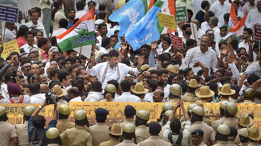KPCC President D K Shivakumar with party workers during a protest rally in support of the party's interim President Sonia Gandhi who appeared before the Enforcement Directorate in connection with the National Herald case, in Bengaluru. Credit: PTI Photo