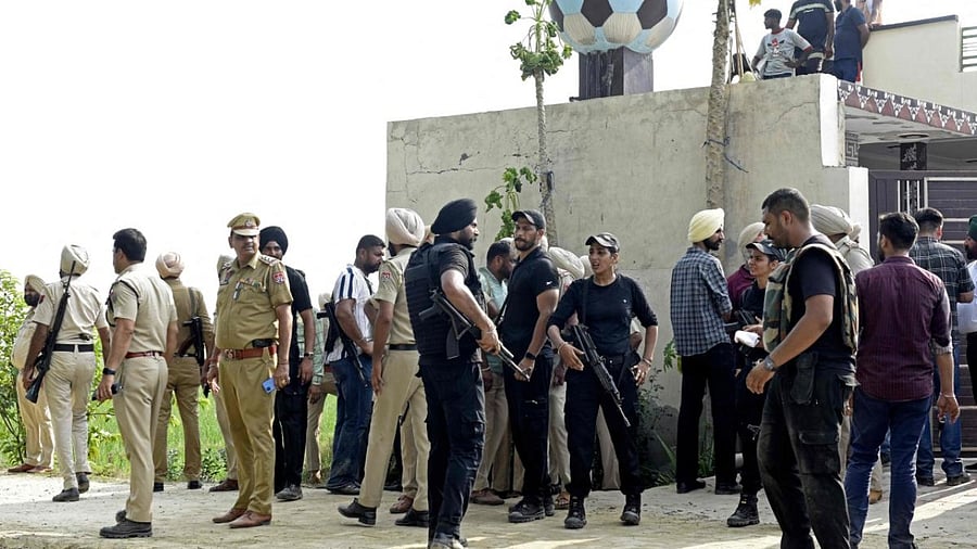 Punjab police personnel and commandos stand guard during an encounter allegedly with gangsters suspected to be involved in the killing of singer Sidhu Moose Wala. Credit: PTI Photo