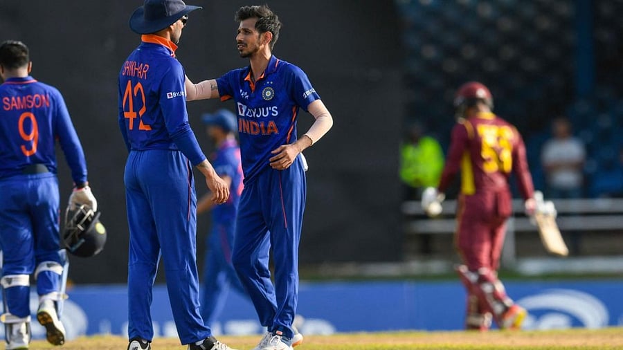 Shikhar Dhawan (L) and Yuzvendra Chahal (2L) of India celebrates the dismissal of Brandon King (R) of West Indies during the 1st ODI match between West Indies and India. Credit: AFP Photo