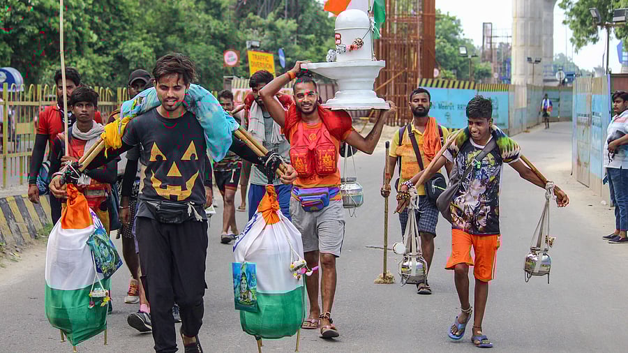 Kanwariyas carrying a Shivling and holy water. Credit: PTI Photo