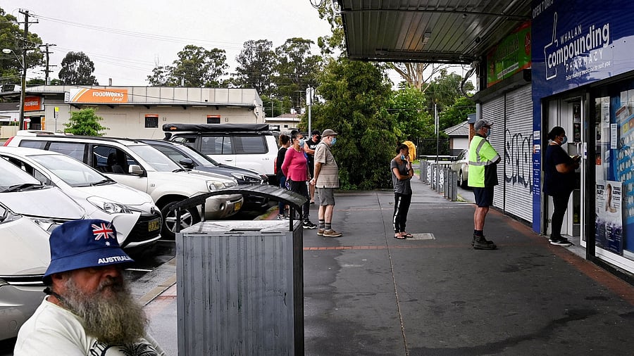 Customers queue outside a Western Sydney chemist to purchase Rapid Antigen Test kits in the wake of the coronavirus disease. Credit: Reuters File Photo