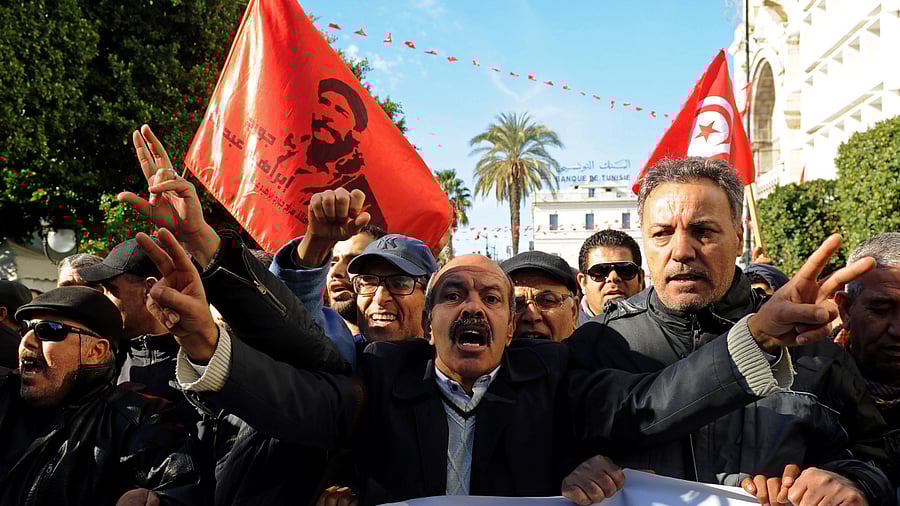 Tunisian workers shout slogans against the government in front of the Tunisian General Labour Union (UGTT) headquarters in Tunis as they mark the seventh anniversary since the uprising that launched the Arab Spring, on January 14, 2018. Credit: AFP File Photo
