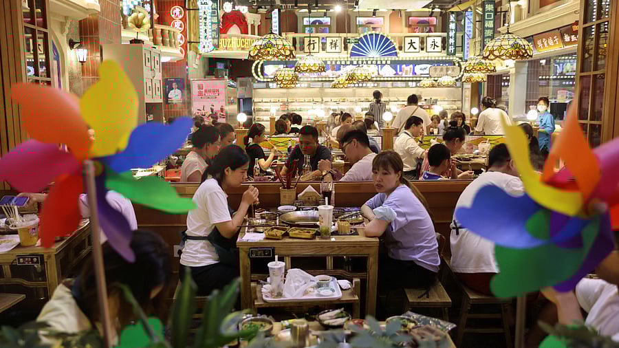 Customers dine at a restaurant in a shopping area in Beijing, China July 25, 2022. Credit: Reuters Photo