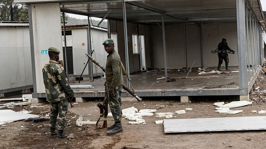 This image taken in Goma on July 26, 2022 shows Congolese soldiers guarding of a looted UN base of the UN peacekeeping mission in Democratic Republic of Congo, MONUSCO. Credit: AFP Photo