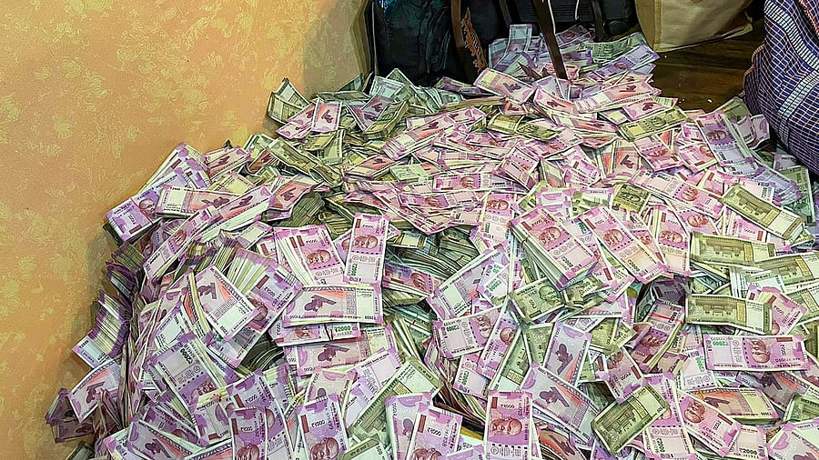Crores of rupees in cash were allegedly seized from the residence of a woman, who apparently happens to be a close associate of senior TMC leader and state minister Partha Chatterjee, according to ED sources. Credit: PTI Photo