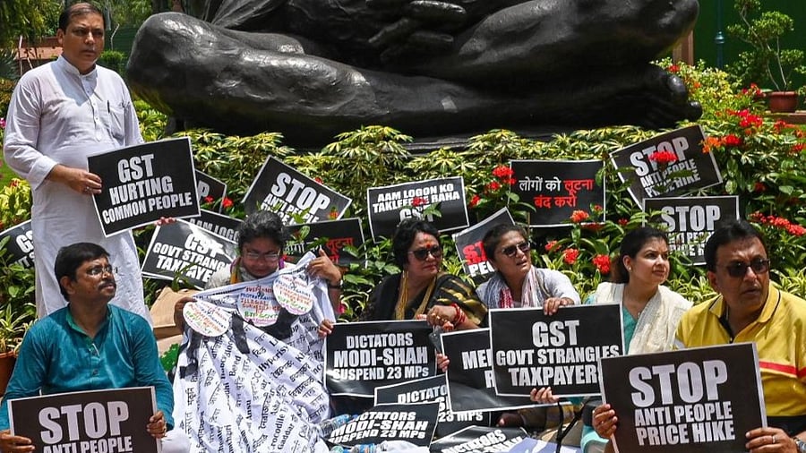 The suspended Members of Parliament (MP) of All India Trinamool Congress (AITC) from Rajya Sabha, take part in a protest against price hike and implementation of Goods and Services Tax (GST) on milk related food products and their suspension for a week at the Parliament in New Delhi on July 27, 2022. Credit: AFP Photo
