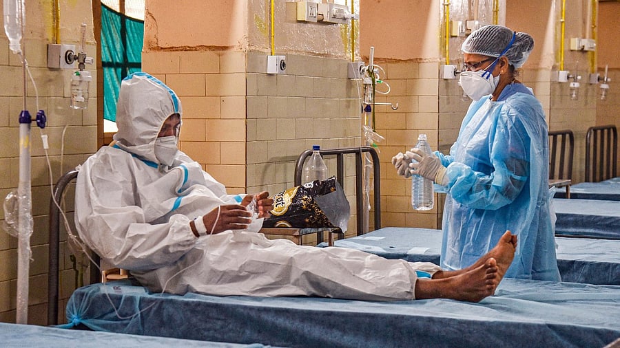 A healthcare worker inspects a patient who showed symptoms of monkeypox after returning from abroad to Kamareddy district. Credit: PTI Photo