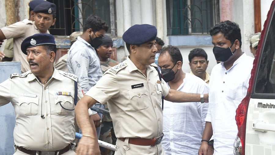 West Bengal police personnel detain three Jharkhand Congress MLAs after a huge amount of cash was found in their vehicle on Saturday. Credit: PTI Photo