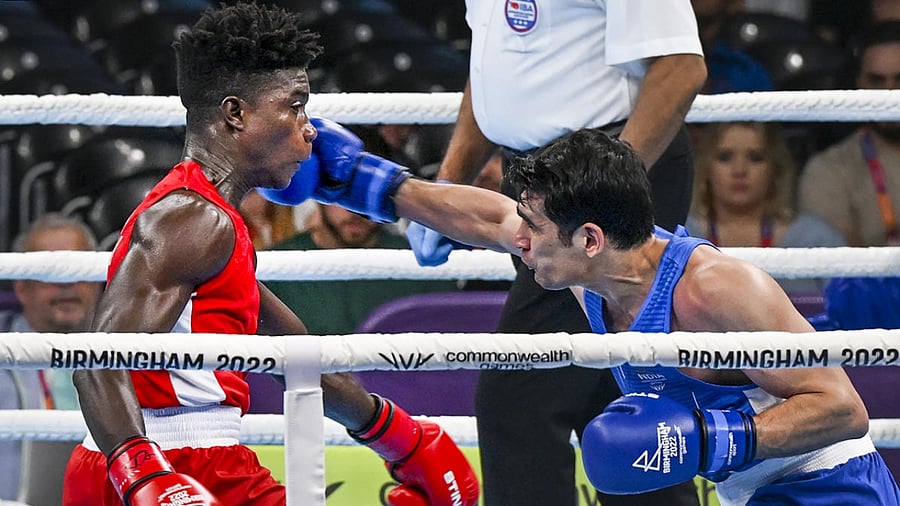 India's Rohit Tokas (blue) lands a punch on Ghana’s Alfred Kotey during the men's over 63.5kg-67kg (Welterweight) Round of 16 boxing match, at the Commonwealth Games 2022 (CWG), in Birmingham, UK, Tuesday, Aug. 2, 2022. Credit: PTI Photo
