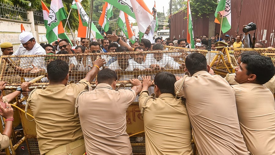 Police personnel try to stop Congress workers during their march towards Raj Bhavan as part of party’s nationwide protest over price rise. Credit: PTI Photo