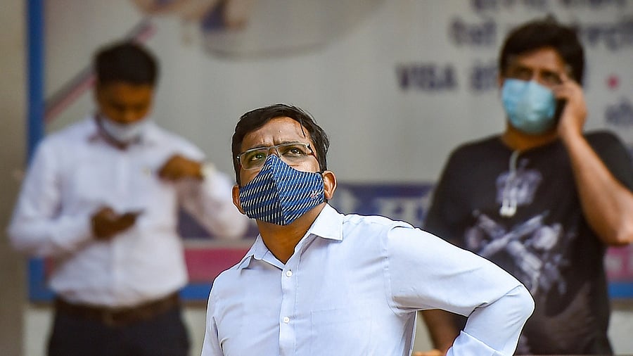 A man watches share prices on an electronic board outside the Bombay Stock Exchange (BSE) in Mumbai. Credit: PTI Photo