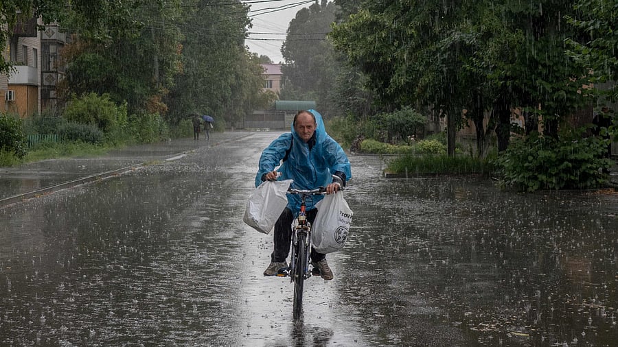 A local resident rides his bicycle Sloviansk, eastern Ukraine, on August 2, 2022, amid the Russian invasion of Ukraine. Credit: AFP Photo 
