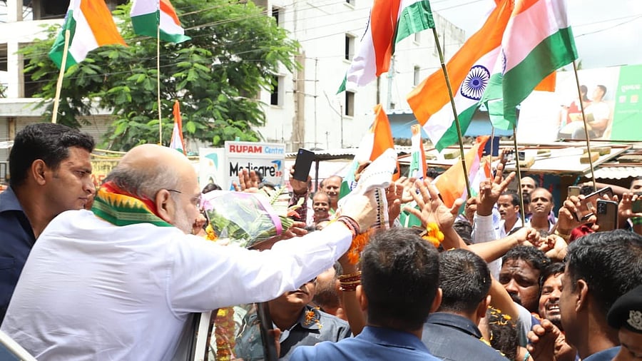 Union Home Minister Amit Shah interacts with supporters during the 'Tiranga Yatra', in Cuttack on Monday, Aug 08, 2022. Credit: IANS Photo