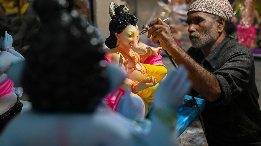 An artisan paints idols of the elephant-headed Hindu god Lord Ganesha ahead of the Ganesh Chaturthi festival. Credit: AFP Photo