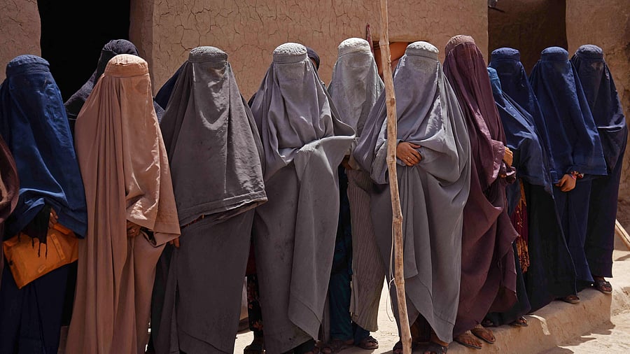 Afghan burqa-clad women workers at a shampoo and soap factory in Kandahar. Credit: AFP Photo