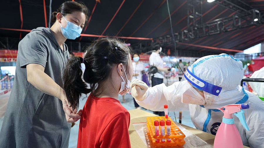 A health worker conducting a swab test. Credit: AFP Photo