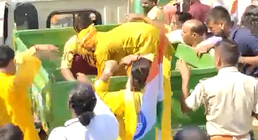 Still from the viral video showing tricolours being distributed from a garbage van. Credit: Twitter