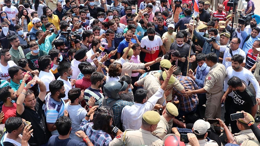 Kashmiri Pandits migrants hold placards and shout slogans during their protest for their safe relocation after the series of suspected target killings in Kashmir Valley. Credit: IANS Photo