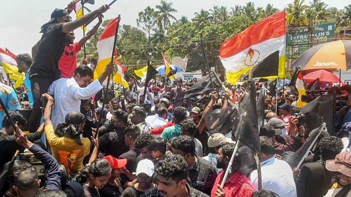 Fishermen and locals holding black flags stage a protest against Adani Groups' port development project at Vizhinjam. Credit: PTI Photo