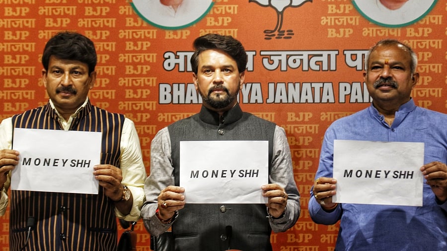 Union Minister Anurag Thakur, Delhi BJP State President Adesh Gupta and Lok Sabha MP Manoj Tiwari during a press conference at BJP Headquarters. Credit: IANS Photo