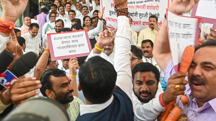 Opposition and rebel Shiv Sena MLAs raise slogans against each other outside the Maharashtra Assembly during its ongoing Monsoon session, in Mumbai, Wednesday, Aug. 24, 2022. Credit: PTI Photo