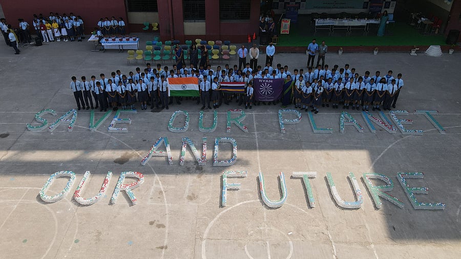 In 9.02 minutes, Licypriya arranged the plastic bottles into lines and wrote "Save our Planet and our Future" at Ryan International School in Noida Extension. Credit: Twitter/ @LicypriyaK