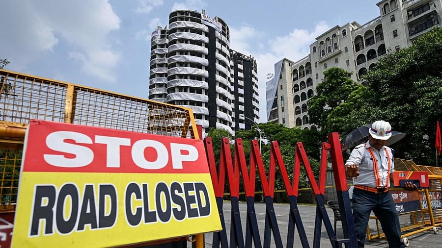 Police barricades cordon off a road near the 100-meter-high residential twin tower which is slated for demolition by controlled implosion on August 28, in Noida. Credit: AFP Photo