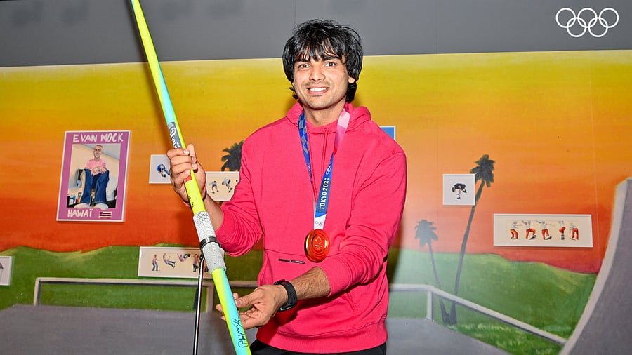 Neeraj Chopra poses with his javelin that won him the gold medal at the Summer Olympics 2020, at The Olympic Museum in Lausanne, Switzerland, August 27, 2022. Credit: PTI Photo