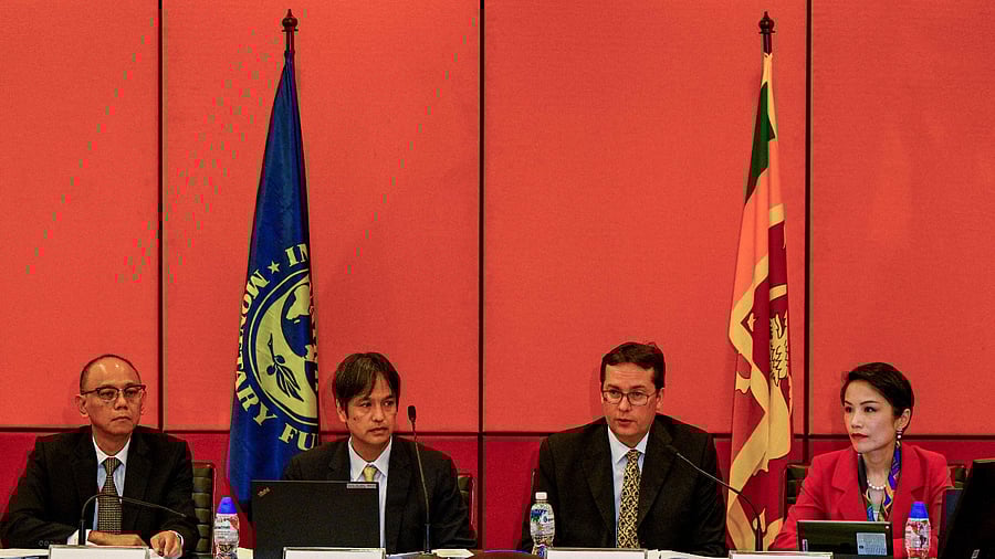 Senior Mission Chief for Sri Lanka of the International Monetary Fund (IMF) Peter Breuer (2R) speaks during a press conference next to Mission Chief for Sri Lanka (IMF) Masahiro Nozaki (2L) in Colombo on September 1, 2022. Credit: AFP Photo