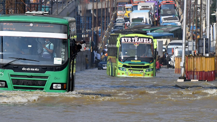 Traffic moves through a water-logged road following torrential rains in Bengaluru. Credit: Reuters Photo