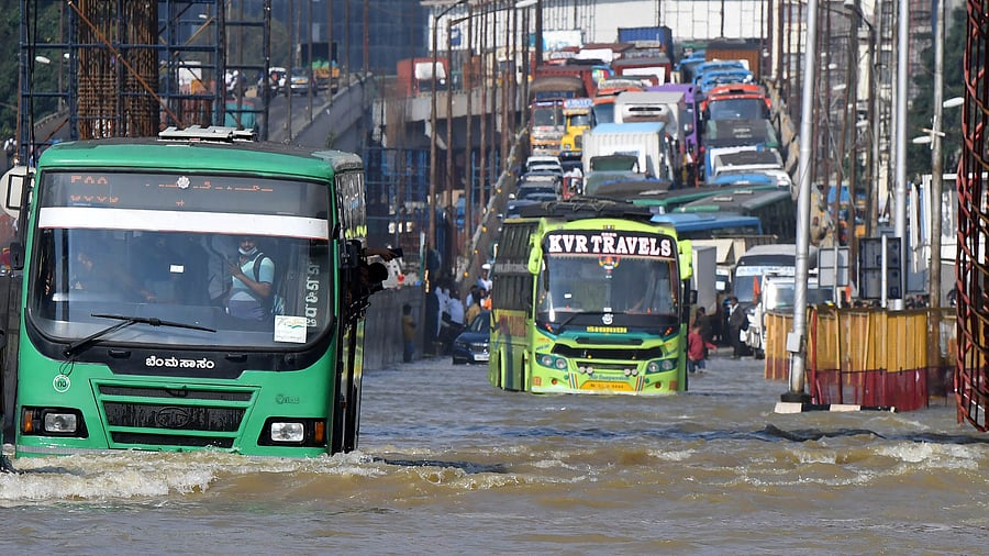 Traffic moves through a water-logged road following torrential rains in Bengaluru. Credit: Reuters Photo