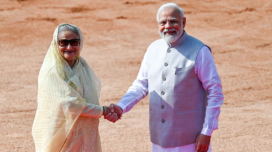 India's Prime Minister Narendra Modi (R) greets his Bangladesh counterpart Sheikh Hasina. Credit: AFP Photo