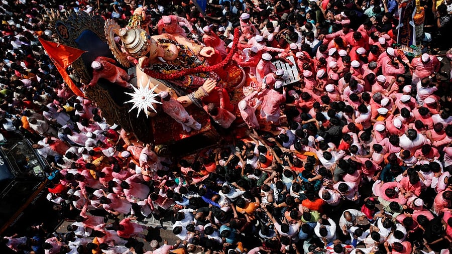 Devotees bid farewell to idol of Ganesh during a procession on the last day of the Ganesh Chaturthi festival, in Mumbai. Credit: Reuters Photo