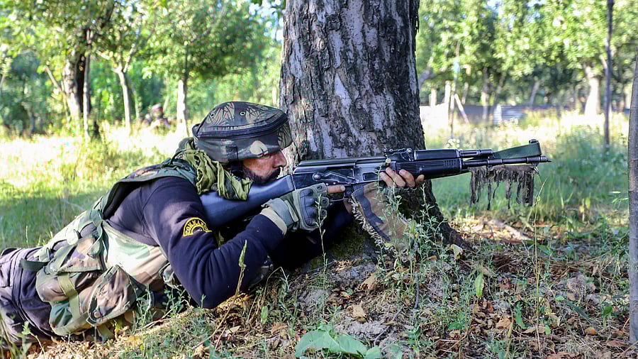 A security personnel during an encounter with militants at Kralgund area of Handwara in Kupwara district of Jammu and Kashmir. Credit: PTI Photo