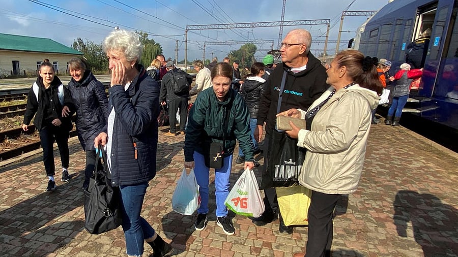 Family backs to their recently liberated home town of Balakliia. Credit: Reuters Photo