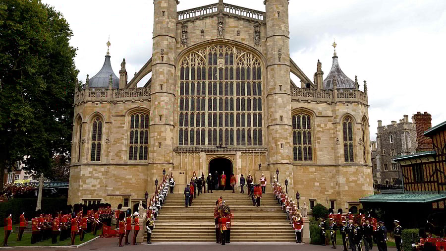 Pall bearers carry the coffin of Queen Elizabeth II with the Imperial State Crown resting on top into St. George's Chapel at Windsor Castle on September 19, 2022. Credit: AFP Photo