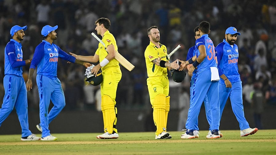Australia's Matthew Wade (centre R) and teammate Pat Cummins (centre L) greet Indian players after winning the first Twenty20 international cricket. Credit: AFP Photo