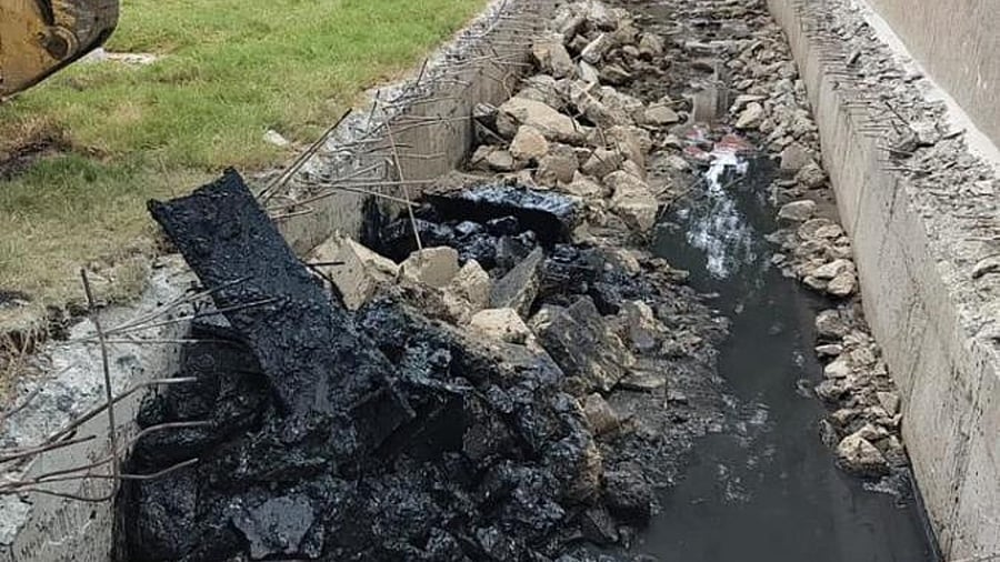 Bagmane hires workers to raze the upper slab of the rajakaluve passing through its premises in Mahadevapura. Credit: DH Photo