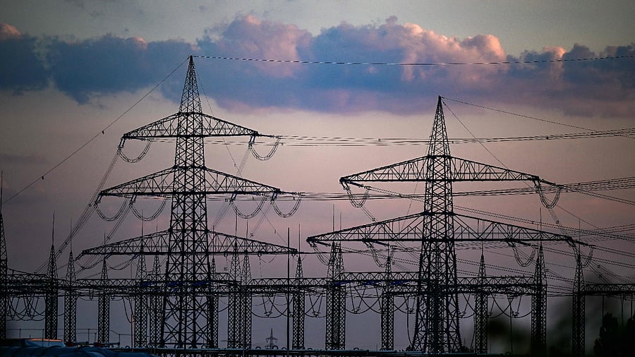 Power pylons are pictured at an industrial area in Herne, western Germany, on August 25, 2022. Credit: AFP File Photo